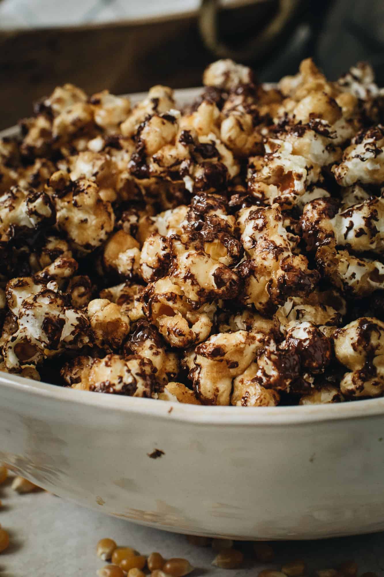 chocolate drizzled popcorn in large white bowl