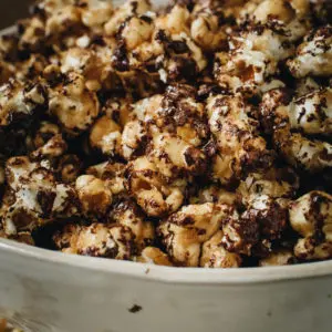 chocolate drizzled popcorn in large white bowl