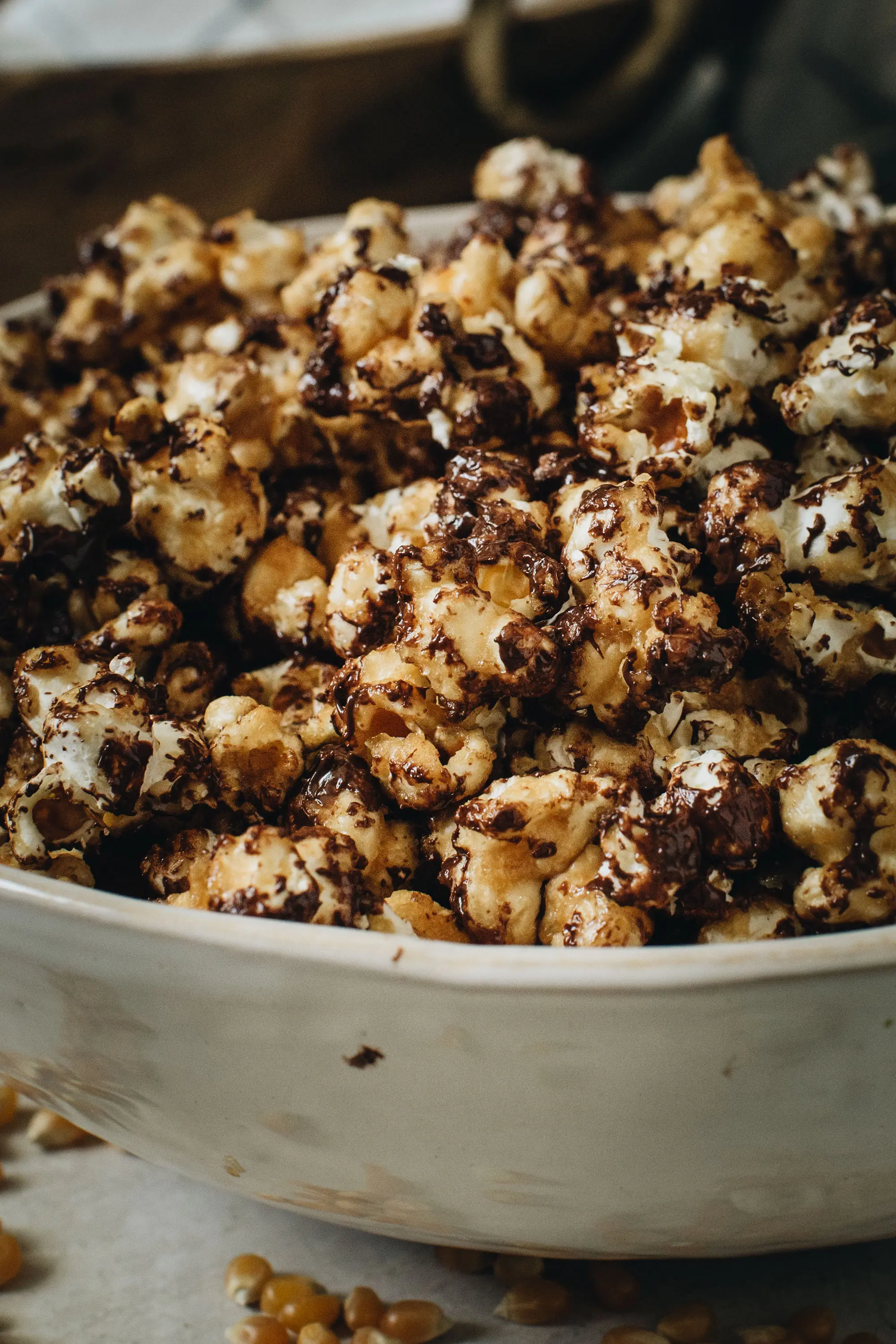 chocolate drizzled popcorn in large white bowl