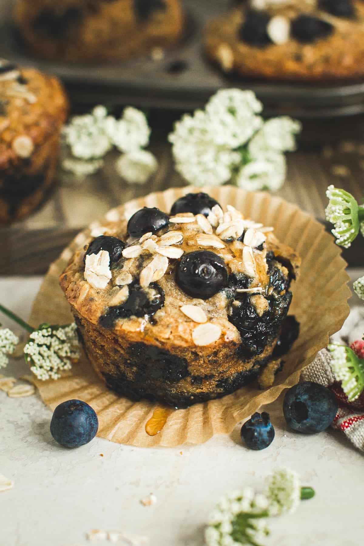 Blueberry oatmeal muffins with honey drizzled on top.