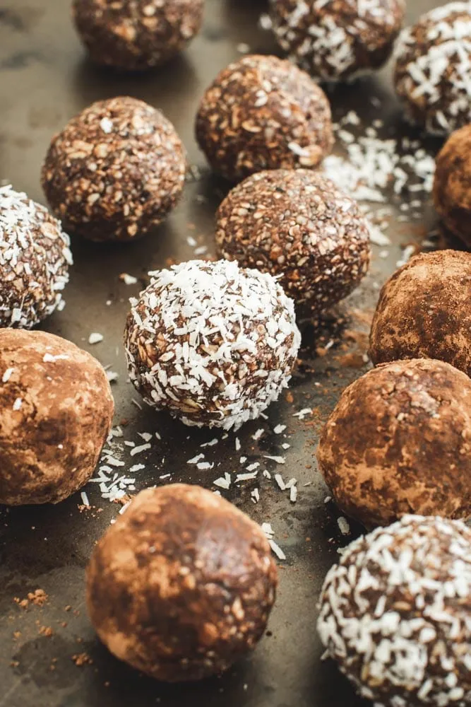 Healthy bliss balls covered in coconut flakes and some in cocoa.