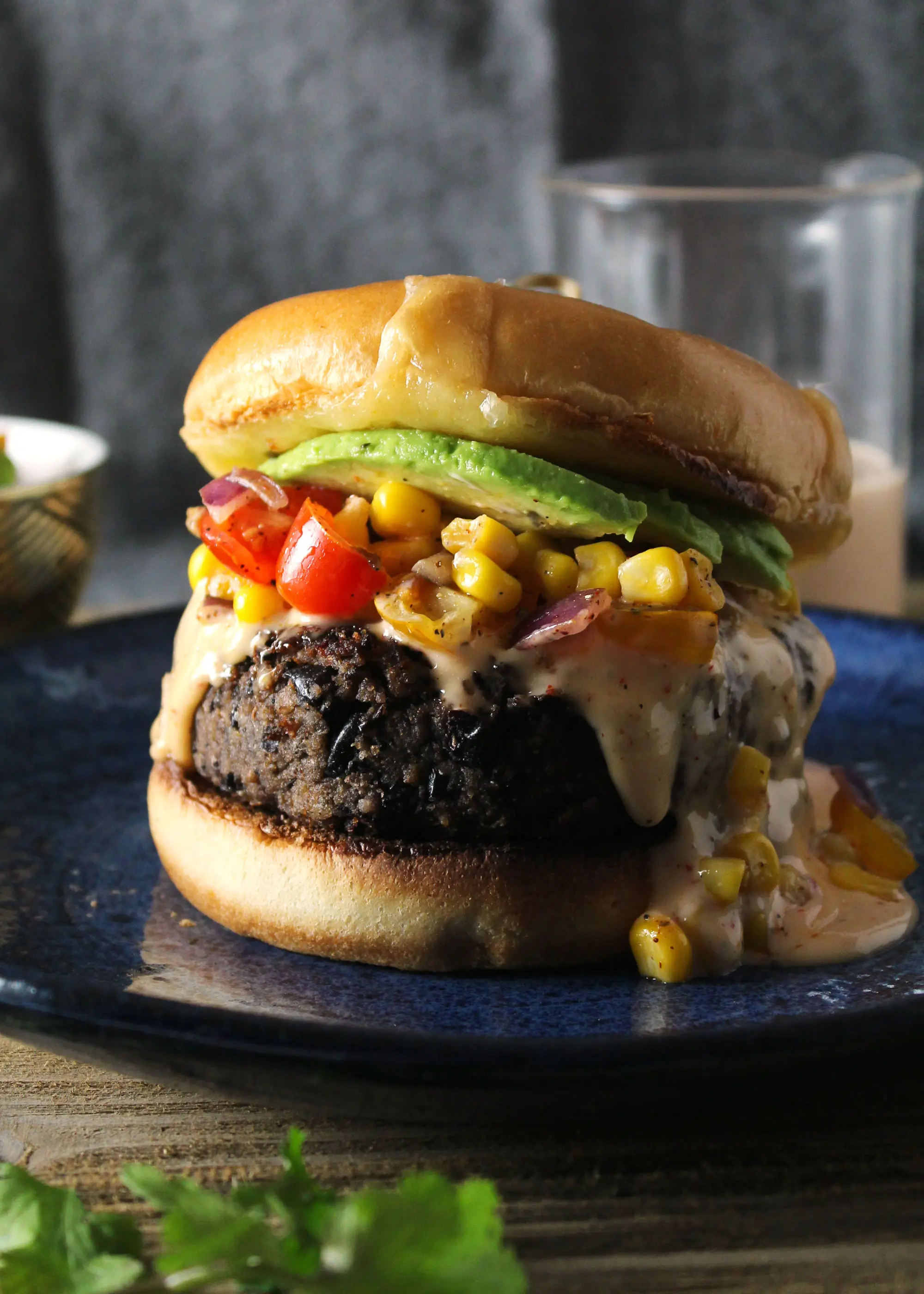 southwest black bean burger with avocado on a blue plate