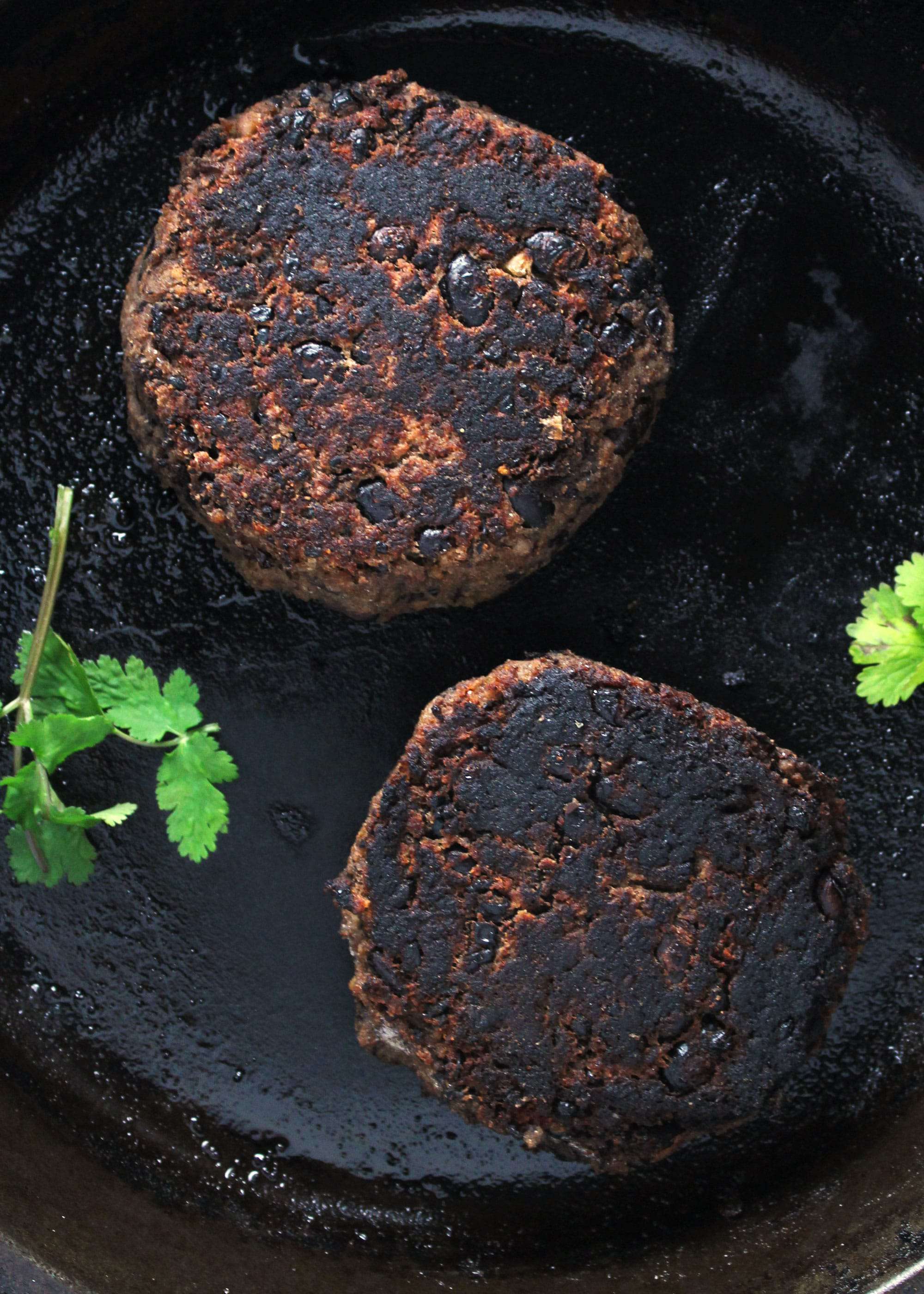 Southwest black bean burger patties in the skillet.