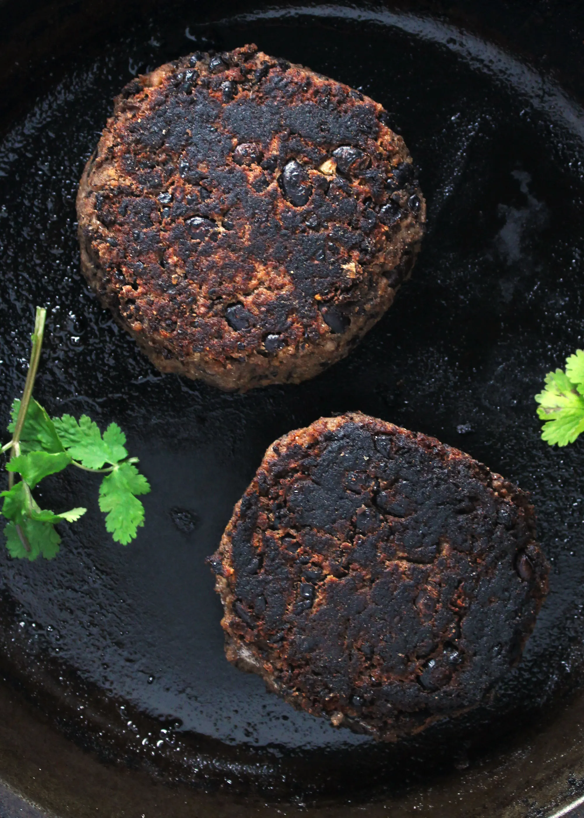 Southwest black bean burger patties in the skillet.