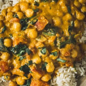 Chickpea spinach curry over rice close up.