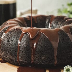 Chocolate ganache dripping down side of chocolate bundt cake.