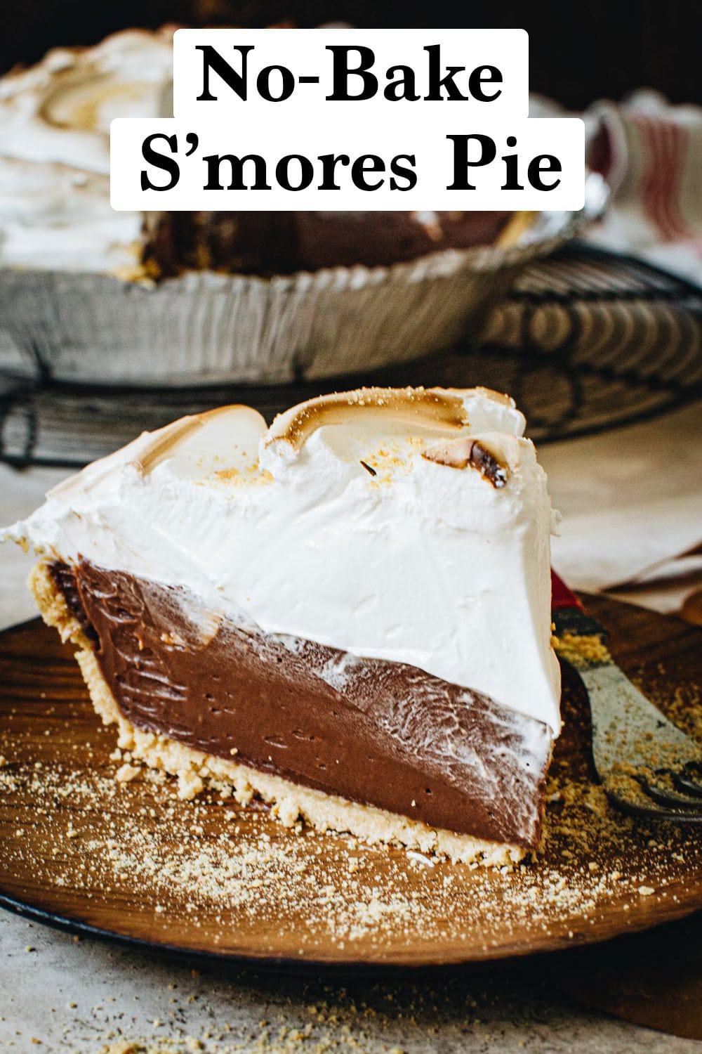 Easy no-bake s'mores pie slice on a wooden plate.