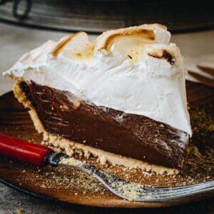 No-Bake S'mores Pie slice on a wooden plate.