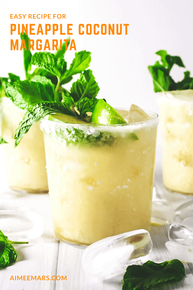 Three pineapple coconut margaritas topped with lime and mint leaf.