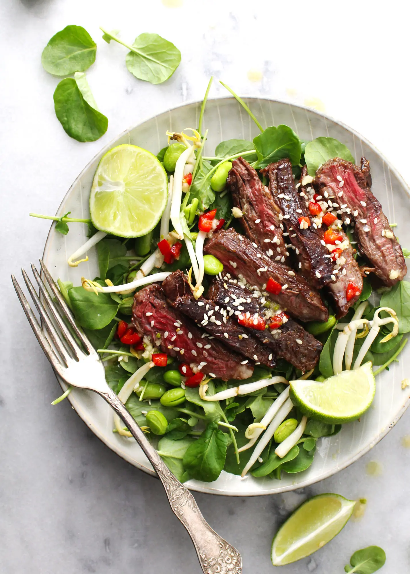 Korean BBQ Steak Salad on gray dish
