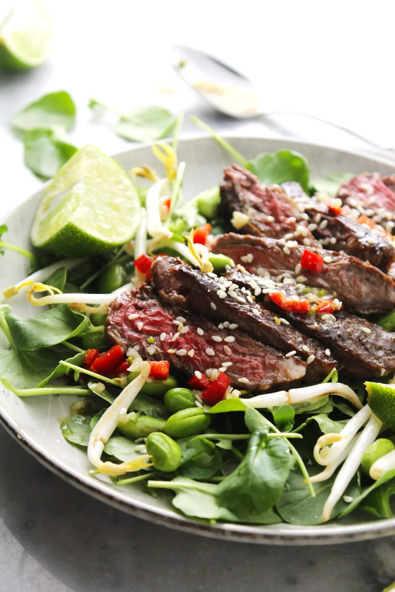 Korean BBQ Steak Salad on gray dish