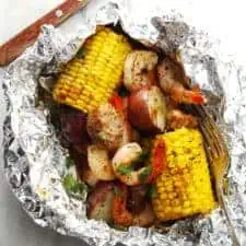 Foil packet Low Country Boil sitting on a marble surface.