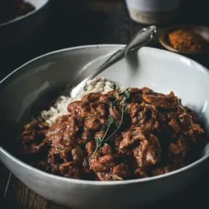 Authentic red beans and rice in a bowl with a silver spoon.