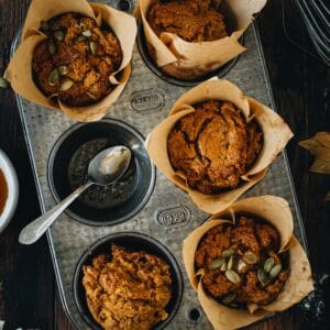 Vegan pumpkin muffins in a muffin tin.