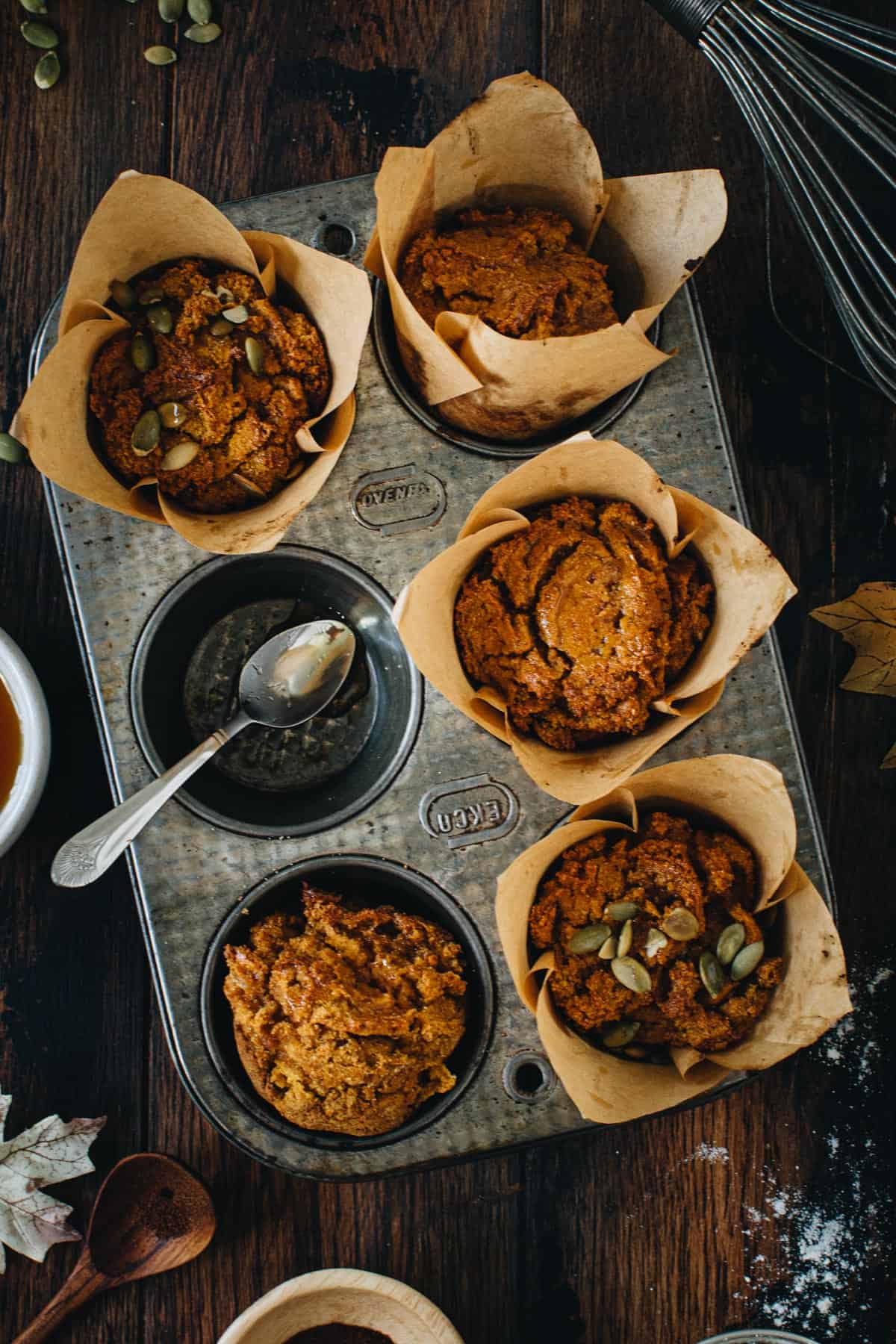 Vegan pumpkin muffins in a muffin tin.