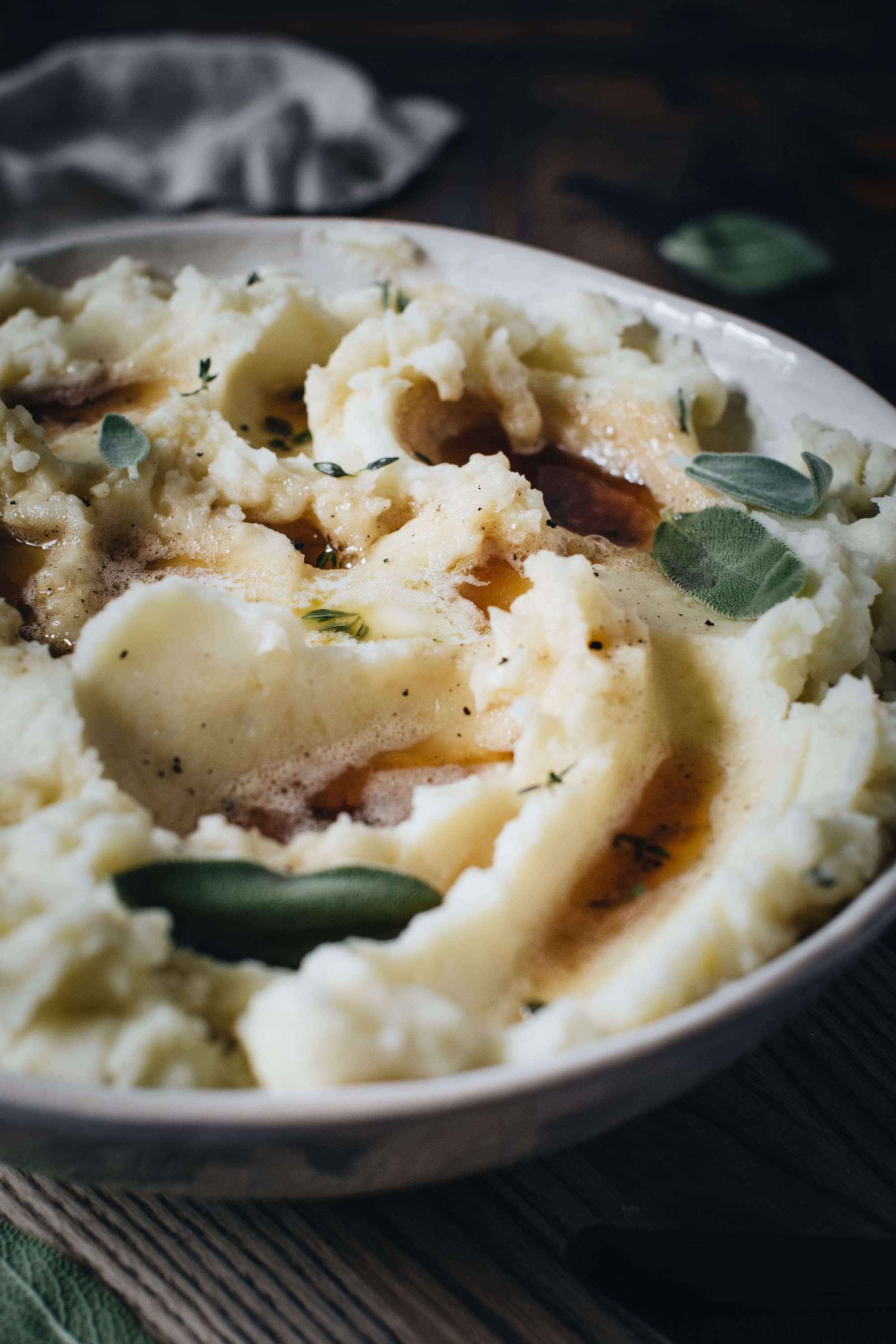 Brown butter potatoes in a bowl with fresh sage.