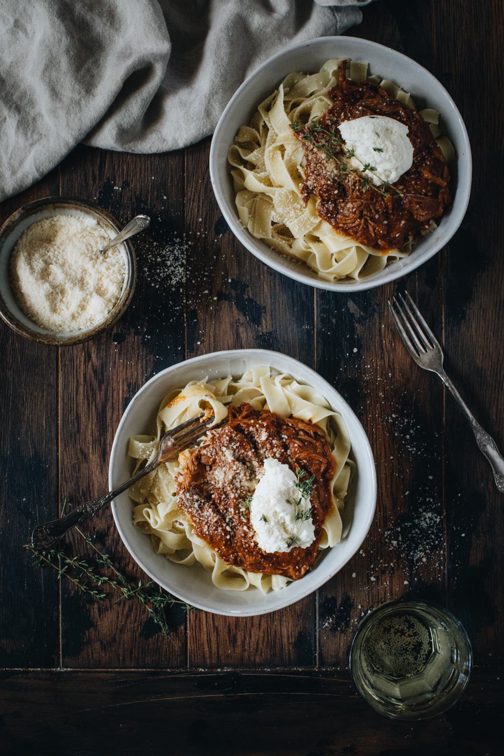 slow cooker beef an pumpkin ragu set on wooden table with cheese