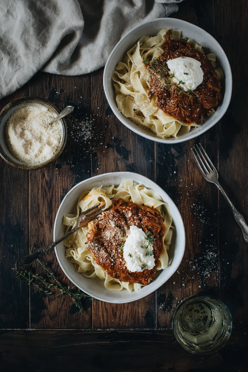 slow cooker beef an pumpkin ragu set on wooden table with cheese