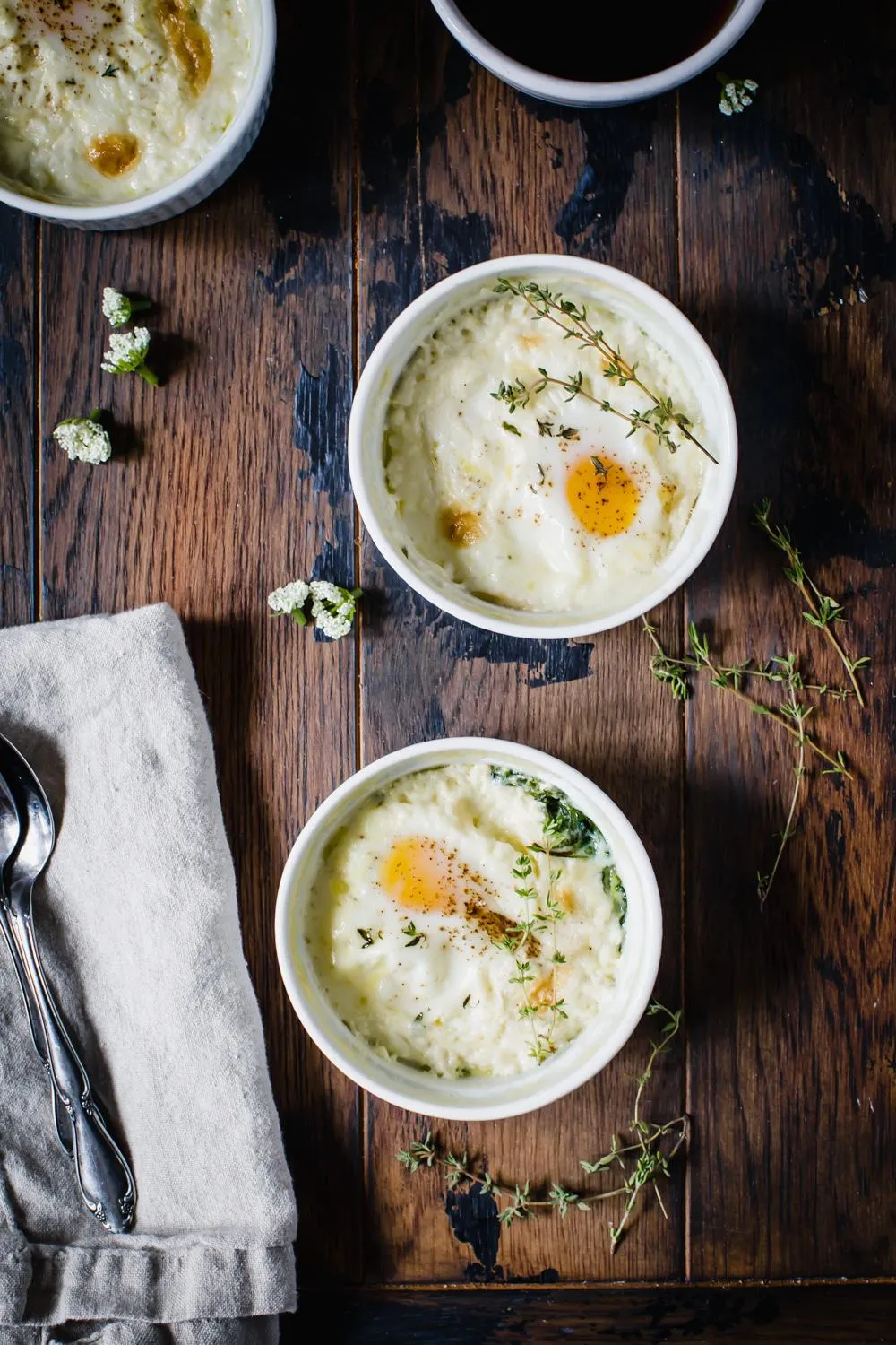 baked eggs in ramekin with linen on wooden table