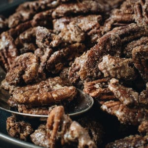 close up shot of cinnamon roasted pecans with spoon