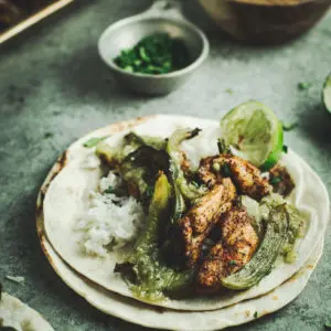 verde chicken fajita with rice and lime on side