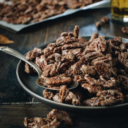 cinnamon roasted pecans on a black plate