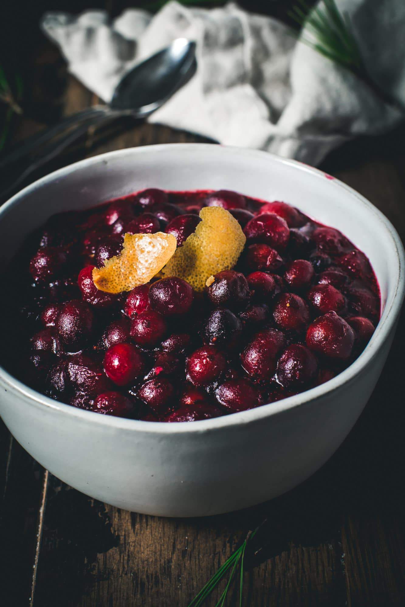 cranberry sauce in white bowl with orange peel