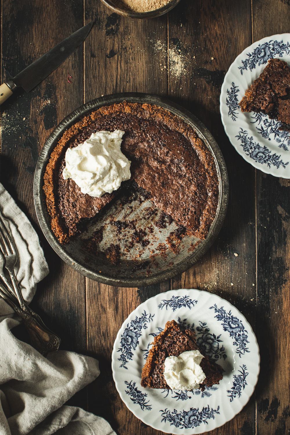 fudge pie in tin pan with slices on blue and white china