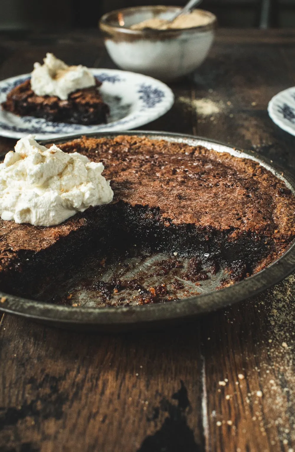 fudge pie with whipped cream in a tin 