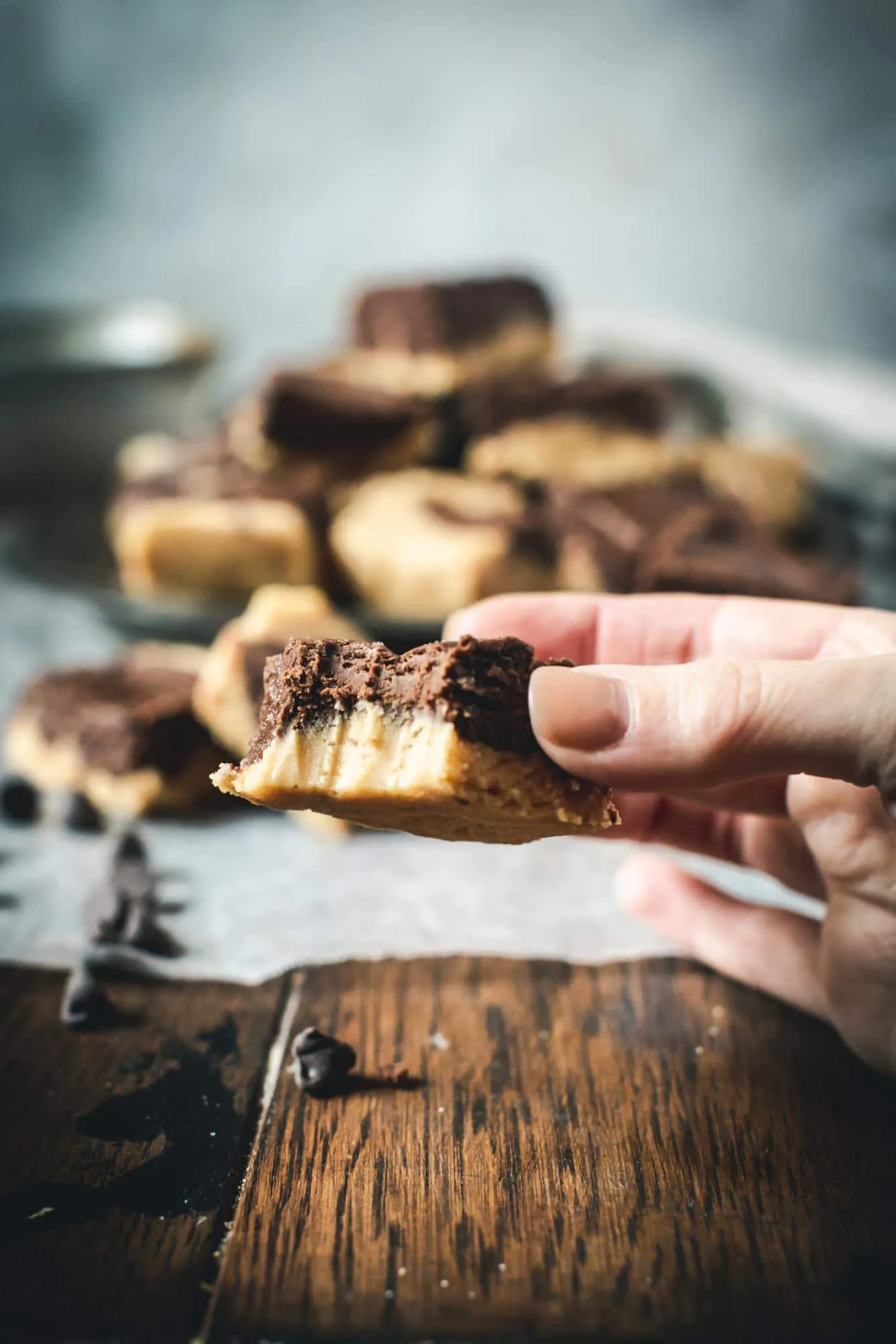 hand holding chocolate peanut butter fudge with a bite taken out