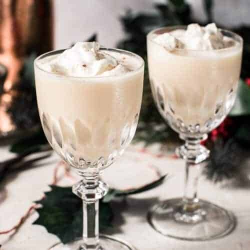 eggnog martini in crystal glasses with whipped cream