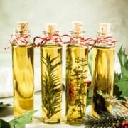 Bottles of infused olive oil with cork stoppers.