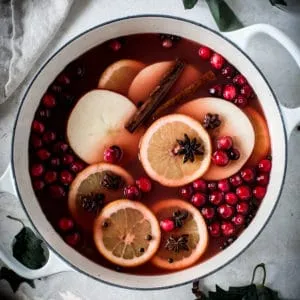 Homemade wassail in a white pot.