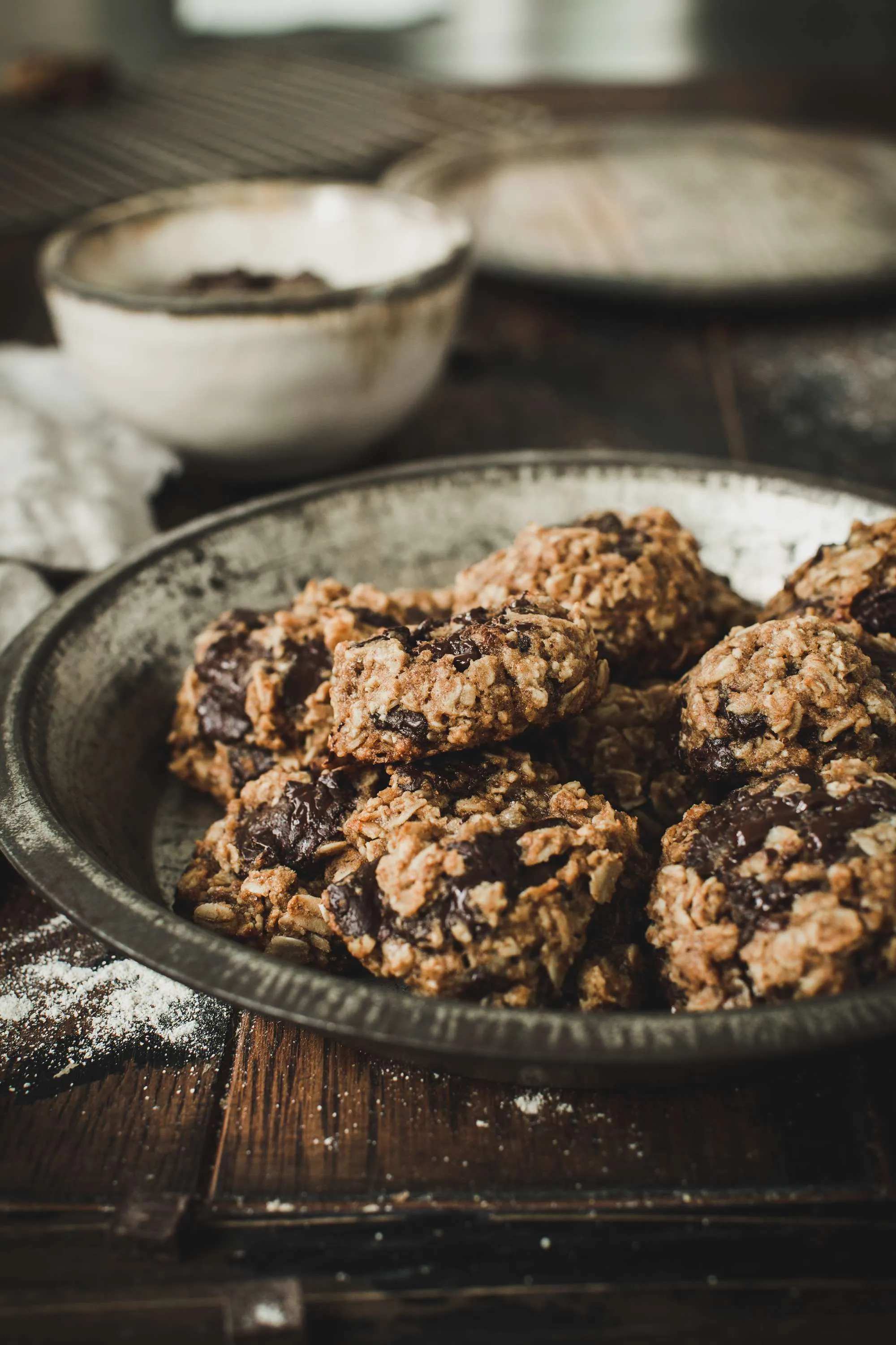 Eggless oatmeal cookies in metal tin.