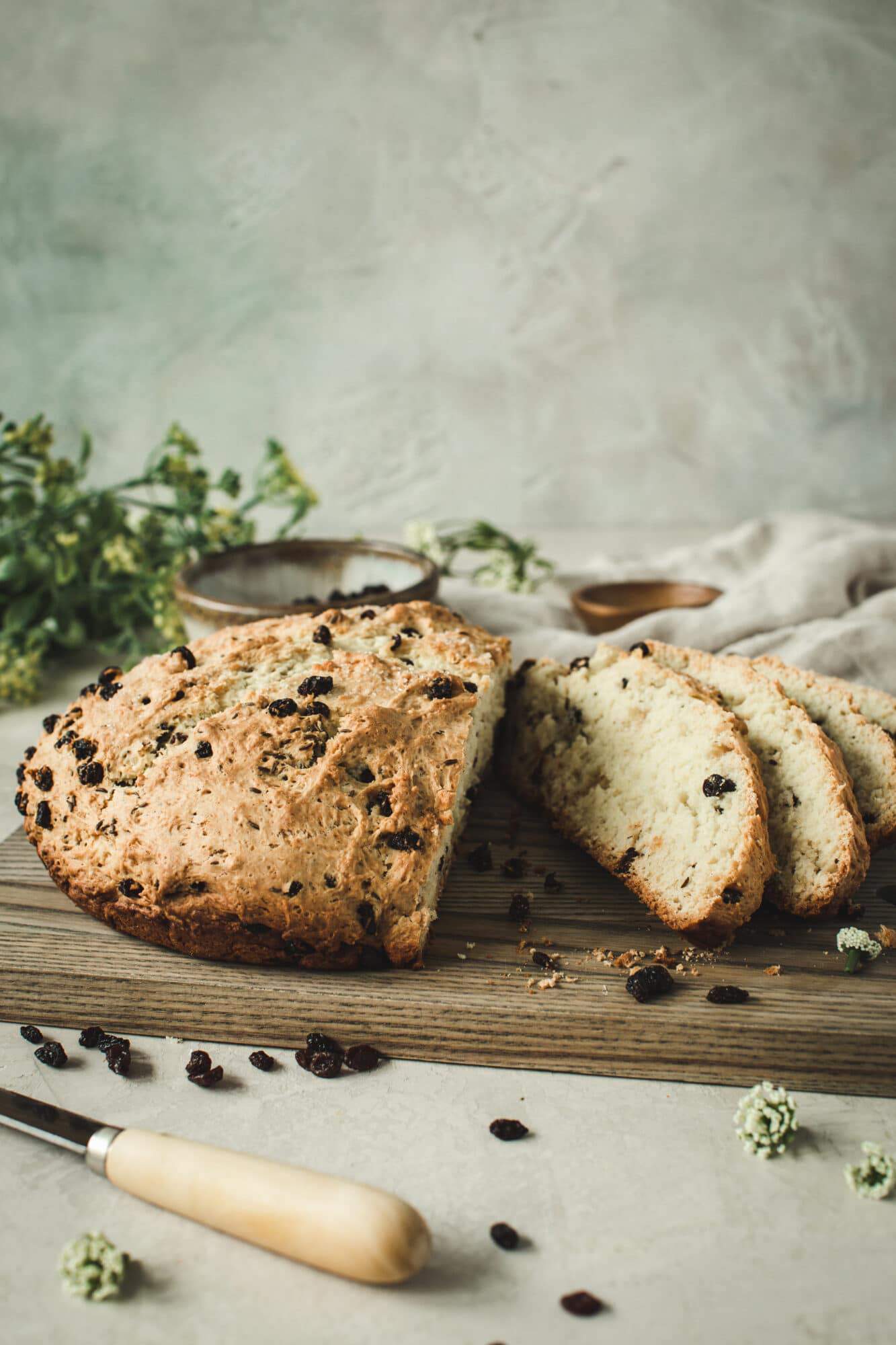 sliced sweet Irish soda bread on wooden cutting board