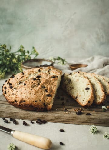 sliced sweet Irish soda bread on wooden cutting board