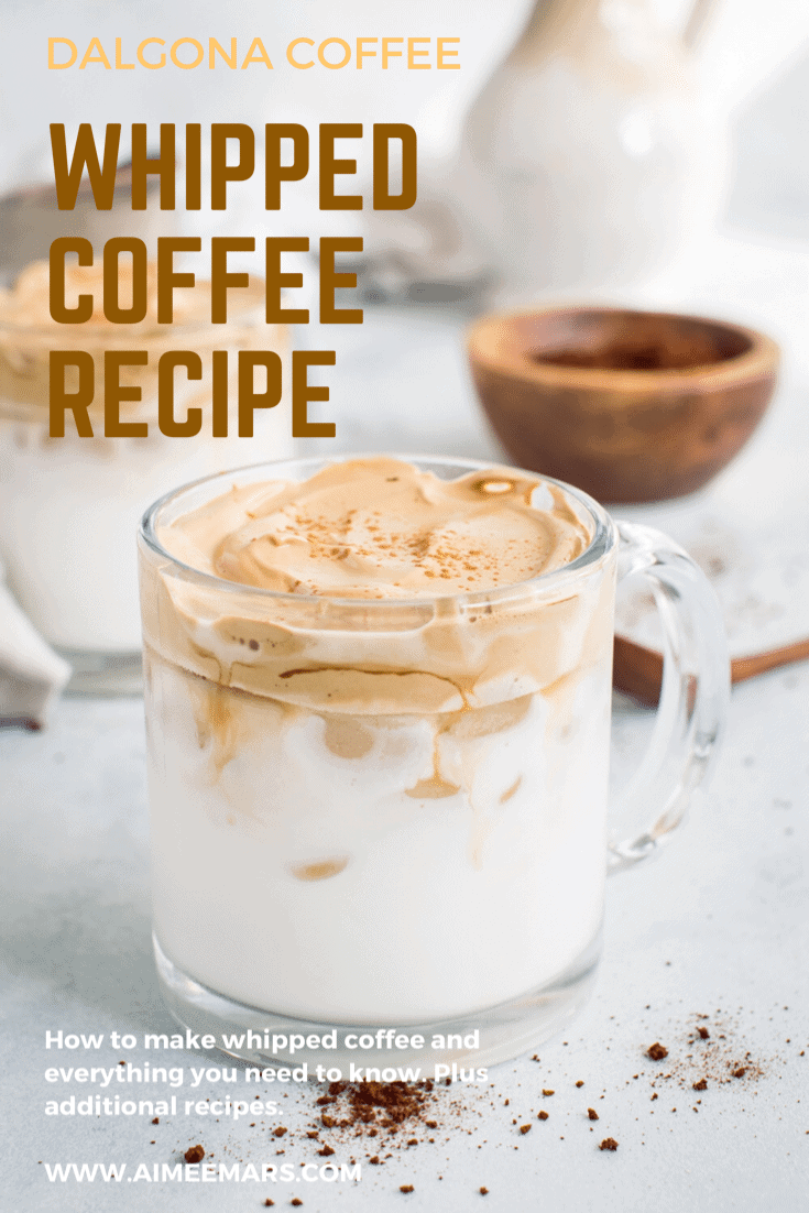 Whipped coffee in clear mug with brown and cream lettering.
