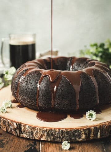 Guinness Chocolate Bundt Cake with ganache being poured on top.