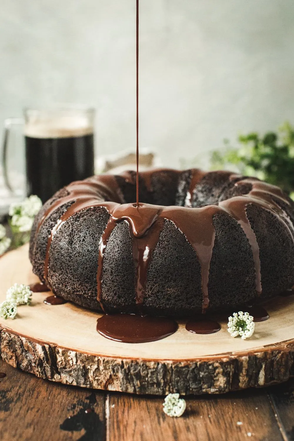 Guinness Chocolate Bundt Cake with ganache being poured on top.