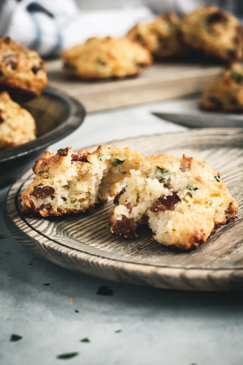 Cheddar Biscuit torn in half on wooden plate