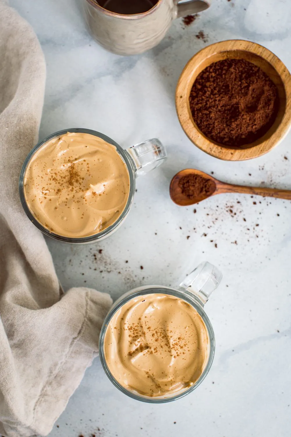 Birds eye view of whipped coffee in two glass mugs