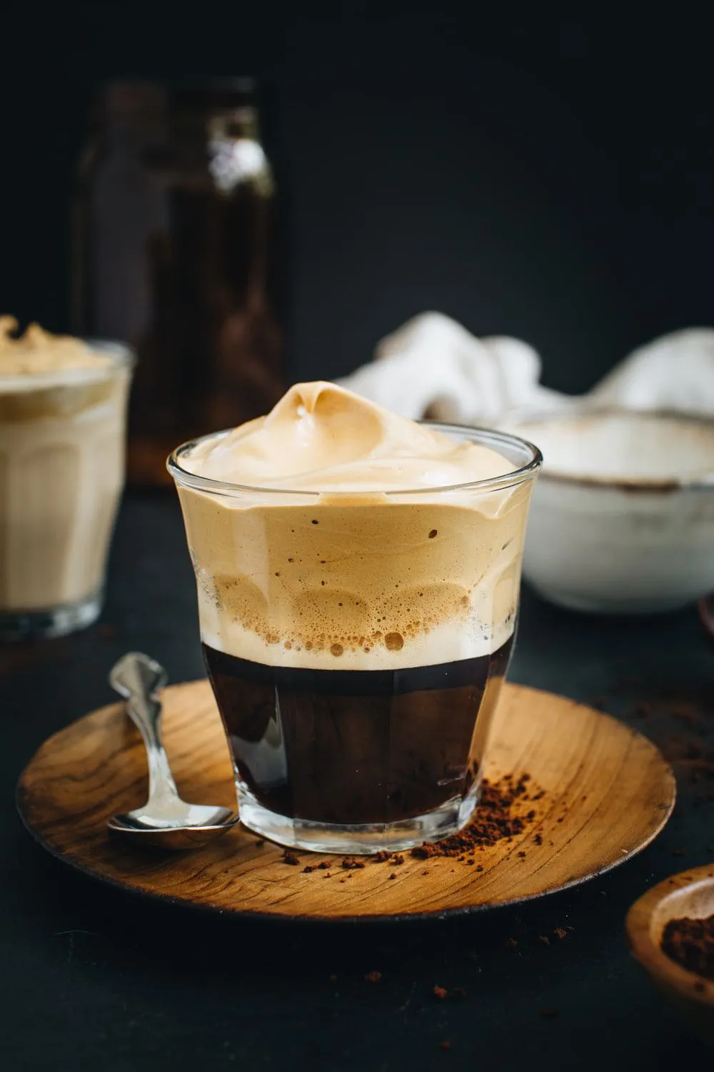 beaten coffee over espresso in a clear glass 