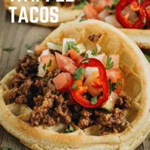 waffle taco with ground beef on wooden cutting board