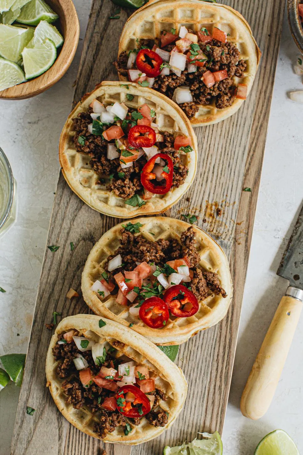 taco waffles on wooden cutting board with knife