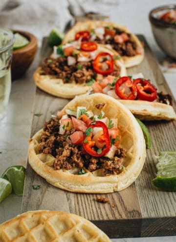 Ground beef waffle taco topped with pico de gallo.