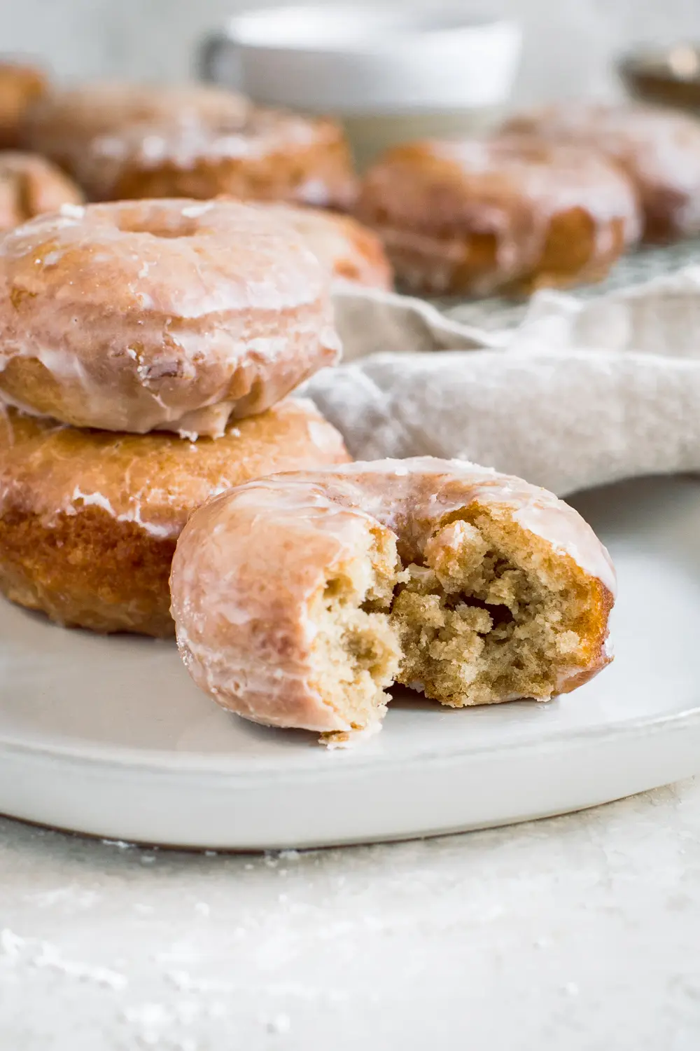 Bite taken out of sour cream cake donut.