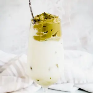 iced dalgona matcha latte with silver spoon in glass