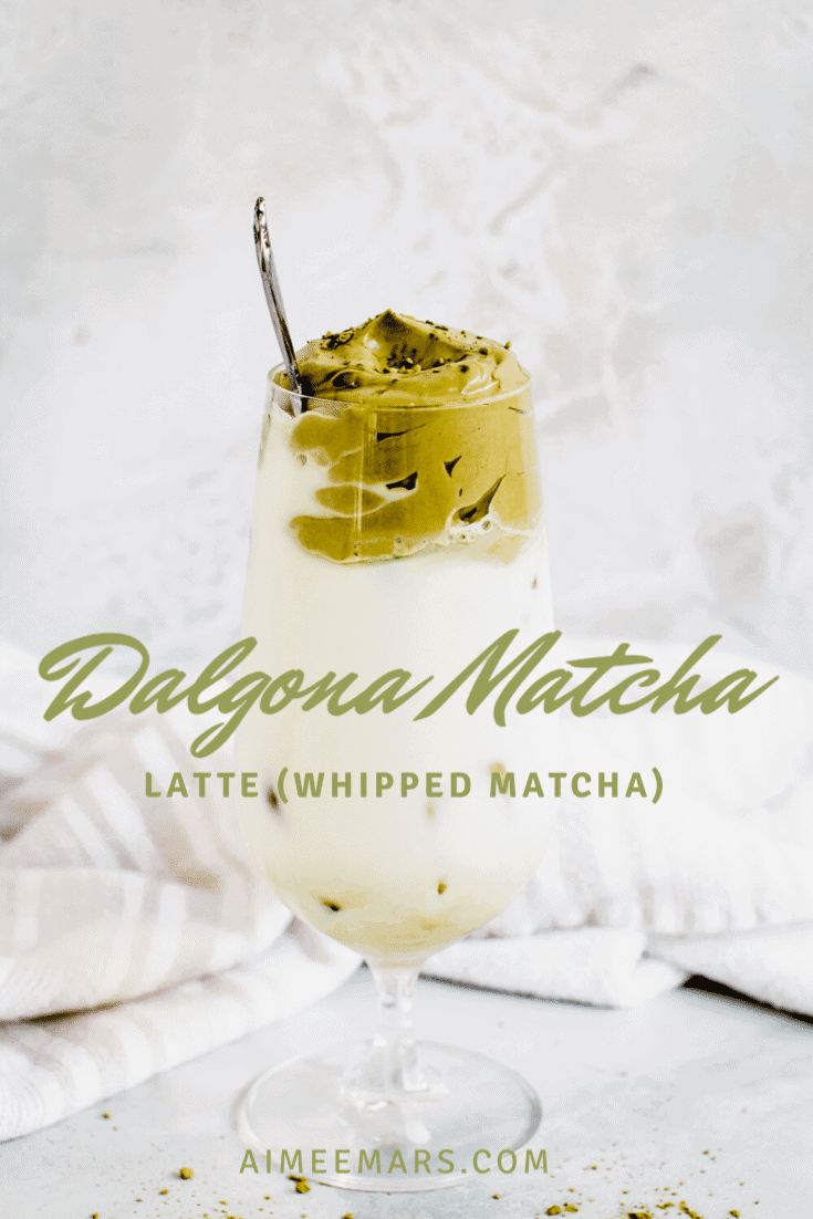 Whipped matcha latte with green lettering.