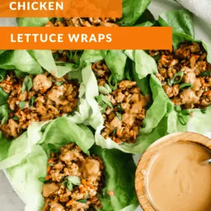 chicken lettuce wraps on round plate with white lettering and orange background