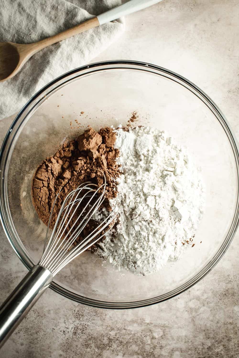 Chocolate banana bread dry ingredients in a mixing bowl with a wire whisk.